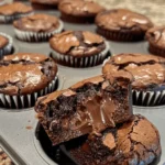 Easy 3-Ingredient Cupcake Brownies freshly baked in a muffin tin topped with chocolate chips