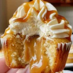 Salted caramel cream cheese cupcakes with gooey caramel filling and creamy frosting, drizzled with salted caramel sauce.