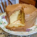 Sour Cream Pound Cake with Caramel Frosting | Moist & Easy Pound Cake Recipe 6 A rich sour cream pound cake topped with thick caramel frosting, sliced and served on a rustic cake stand.