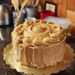 The Best Baptist Pound Cake with Caramel Icing: Southern Comfort in Every Slice 6 Baptist Pound Cake with Caramel Icing on a white cake stand with caramel drizzle and sliced for serving